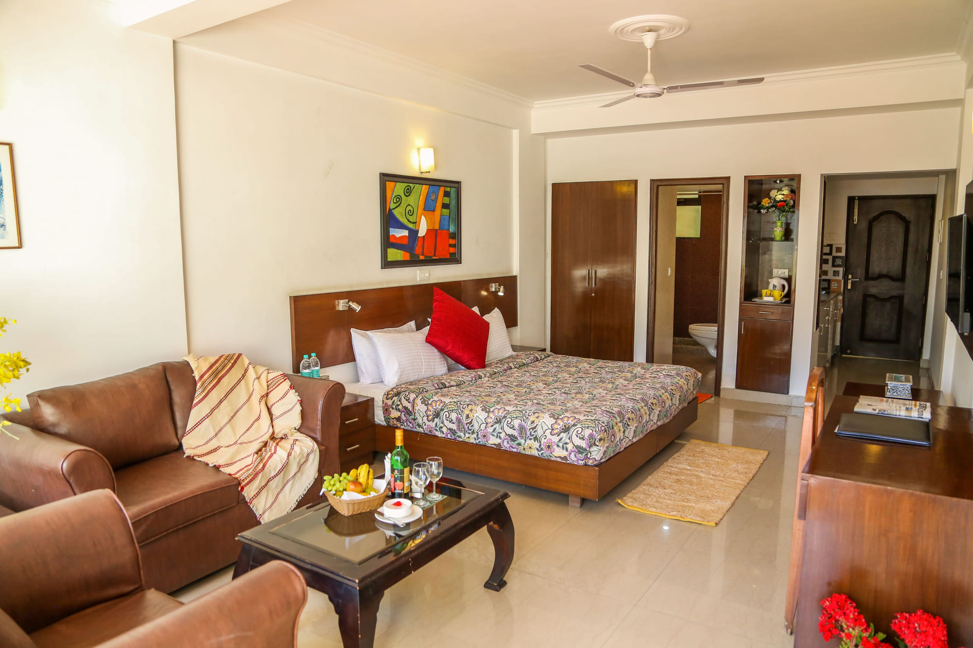 Premium suite with a separate sofa lounge beside the bed